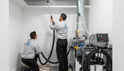 Technician cleaning air ducts for HVAC system in Dallas TX home | Five Star Cooling air duct service