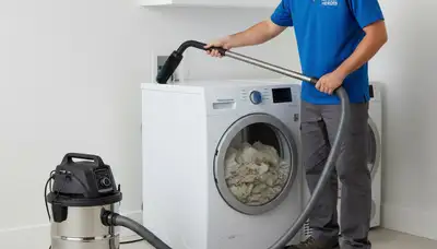 Technician performing professional dryer vent cleaning service in Dallas, TX home